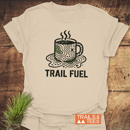 Trail Fuel T-Shirt featuring a topographic map coffee mug illustration with TRAIL FUEL text, highlighting outdoor adventure spirit. Includes durable print and pre-shrunk fit.