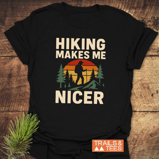 Hiking Makes Me Nicer T-Shirt featuring a retro hiker design with pine trees and mountains. Crafted from soft cotton, pre-shrunk, with durable prints.