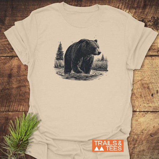 Majestic Grizzly T-Shirt featuring a bear line-art in nature, laid on wood with pine sprig. Soft, ring-spun cotton, durable print, pre-shrunk fit.