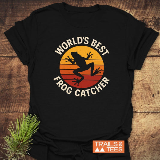 Frog Catcher T-Shirt with retro sunset graphic and frog silhouette, showcasing comfort and durability, perfect for outdoor enthusiasts.