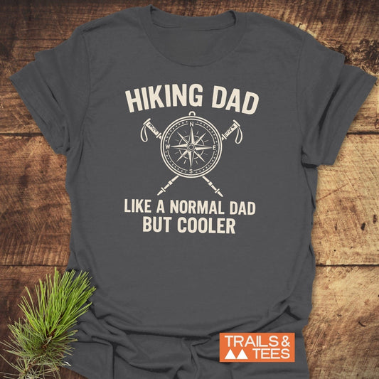 Cool Hiking Dad T-Shirt with compass and hiking poles graphic, soft ring-spun cotton, durable prints, pre-shrunk for reliable fit, and orange Trails & Tees logo.
