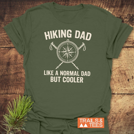 Cool Hiking Dad T-Shirt with compass and hiking poles graphic, crafted from soft cotton for adventure-ready comfort, featuring durable prints and eco-friendly design.