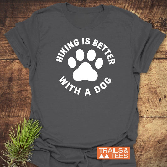 Hiking With Dogs T-Shirt featuring a large dog paw print with text. Made from soft cotton for comfort, showcasing outdoor adventure spirit.