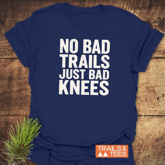 Navy-blue No Bad Trails Funny T-Shirt with white slogan and orange Trails & Tees logo, crafted from soft cotton, laid flat with pine sprig.