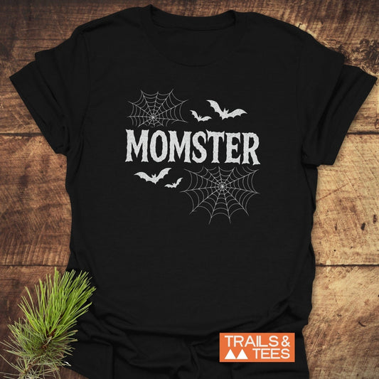 Black MOMSTER T-shirt with horror-style font, spiderwebs, bats; features soft ring-spun cotton and durable prints, designed for outdoor adventures.