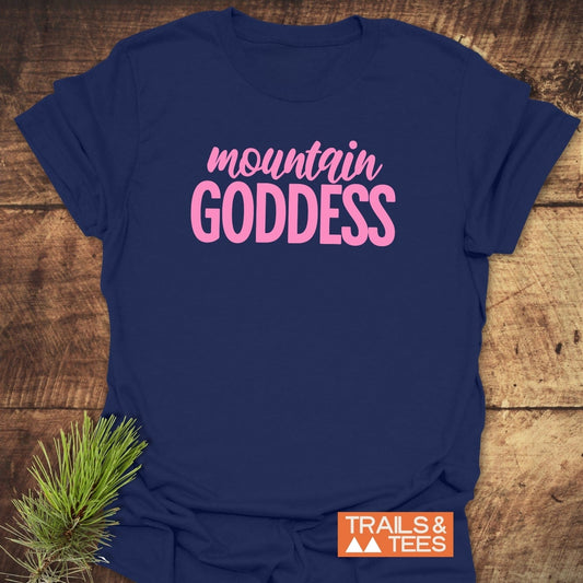 Mountain Goddess T-Shirt with pink chest lettering on navy, orange logo at corner, crafted from soft cotton for comfort and durability, ideal for outdoor adventures.