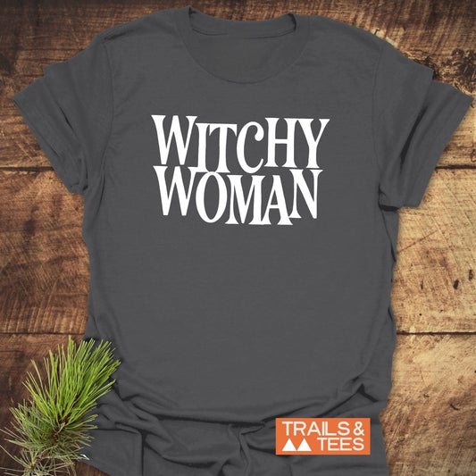 Witchy Woman T-Shirt, dark-gray with “WITCHY WOMAN” in white, displayed flat. Features soft, lightweight cotton with durable prints, emphasizing outdoor comfort and style.