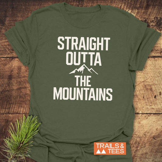 Forest-green Straight Outta The Mountains T-shirt with mountain outline, styled with pine sprig; features durable print, ring-spun cotton, taped shoulders, no side seams.