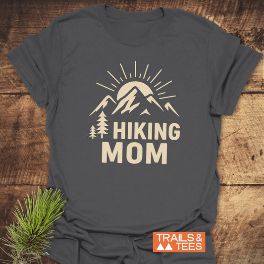 Hiking Mom Sunrise T-Shirt featuring a cream sun and mountain design, crafted from soft cotton. Ideal for outdoor enthusiasts, durable and pre-shrunk for reliability.