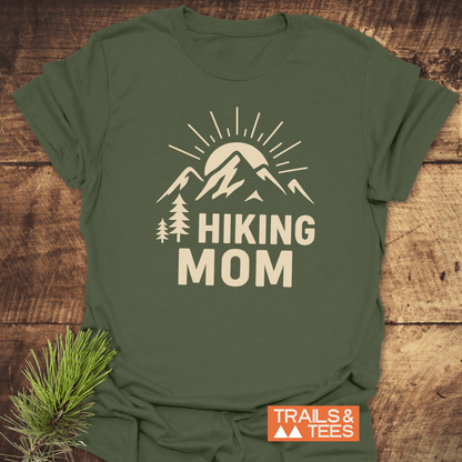Olive-green Hiking Mom Sunrise T-Shirt with stylized mountain print and HIKING MOM text, featuring durable prints and trail-tested comfort for outdoor enthusiasts.