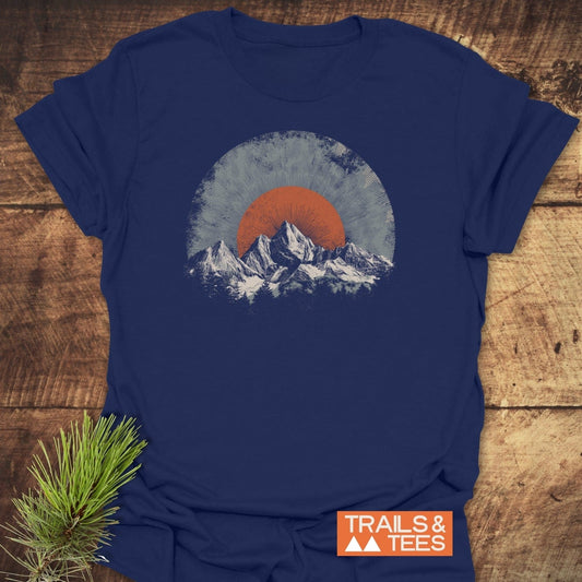 Rocky Mountains Sunset T-Shirt: Navy crew-neck featuring snow-capped peaks and sunburst graphic; soft, lightweight cotton, pre-shrunk, durable print, eco-friendly, fast USA shipping.