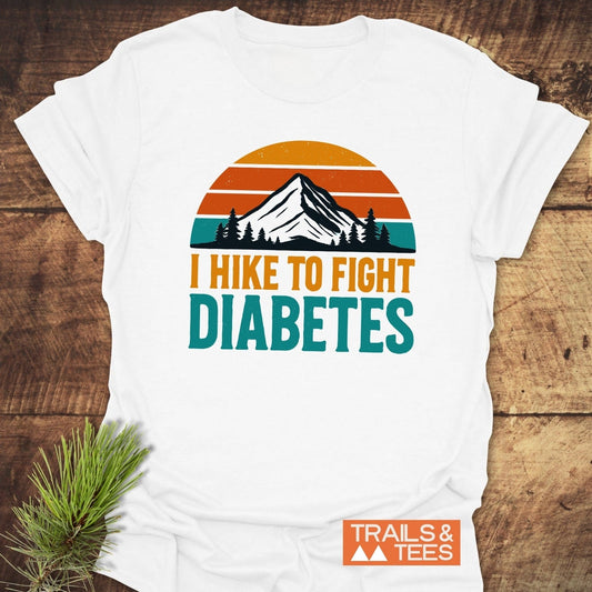 Hike To Fight Diabetes T-Shirt featuring a mountain graphic and bold text. Crafted from soft cotton with durable prints, promoting outdoor spirit and cause awareness.