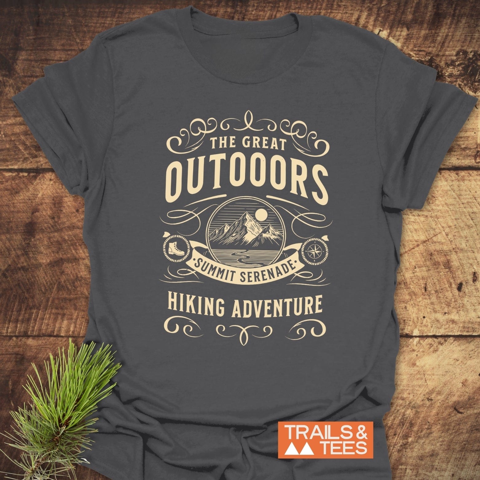 The Great Outdoors T-Shirt with mountain badge, hiking motifs, and Summit Serenade text, showcasing durable design and outdoor spirit.