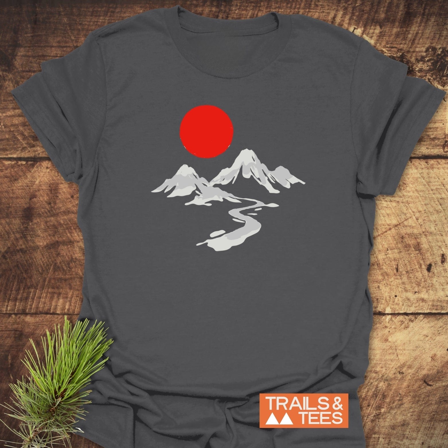 Crimson Sun T-Shirt featuring white mountain peaks and red sun graphic, crafted from soft ring-spun cotton, ideal for outdoor enthusiasts.