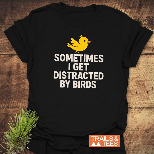 Bird Distraction Funny T-Shirt with yellow bird graphic and quote, crafted from soft ring-spun cotton. Features durable print and Trails & Tees logo.