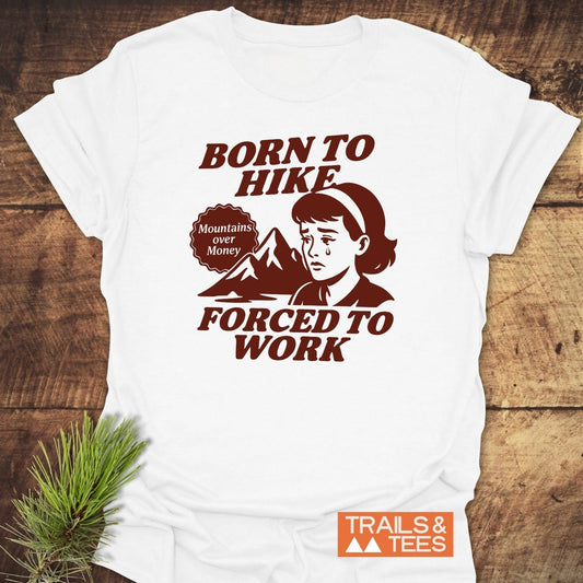 Born To Hike T-Shirt with vintage mountain graphic, retro cartoon, and bold text, crafted from soft cotton, pre-shrunk, durable print, designed for outdoor enthusiasts.