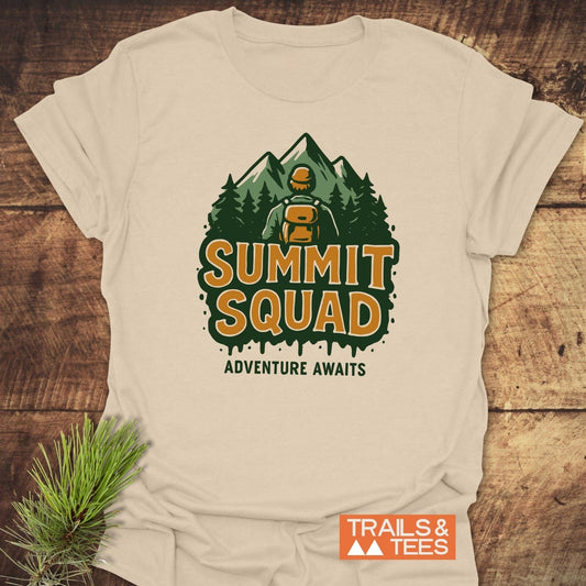 Summit Squad Hiking T-Shirt featuring a hiker graphic with Adventure Awaits slogan. Made from soft ring-spun cotton, designed for comfort and durability.