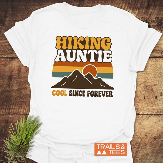 Cool Hiking Auntie T-Shirt with retro graphic, mountain silhouette, and “COOL SINCE FOREVER” slogan, crafted from soft cotton for adventure-ready comfort.
