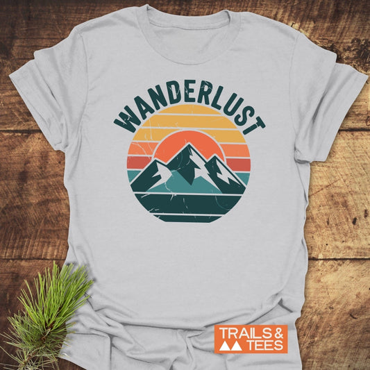 Wanderlust T-Shirt featuring a retro mountain graphic and WANDERLUST text, crafted from soft cotton for comfort, durability, and outdoor adventures.