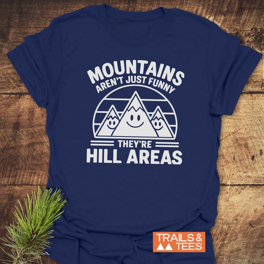 Navy-blue T-shirt featuring cartoon mountains, humorous text, and TRAILS & TEES logo. Made from soft cotton, ideal for outdoor enthusiasts.
