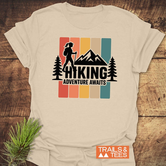 Hiking Girl T-Shirt featuring a retro graphic with a hiker silhouette and slogan HIKING ADVENTURE AWAITS, crafted from soft, durable cotton, ideal for outdoor enthusiasts.
