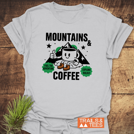 Mountains & Coffee Retro T-Shirt with a graphic of a hiking mug and mountain range, featuring slogans “Fuel the Adventure” and “Explore Boldly.”