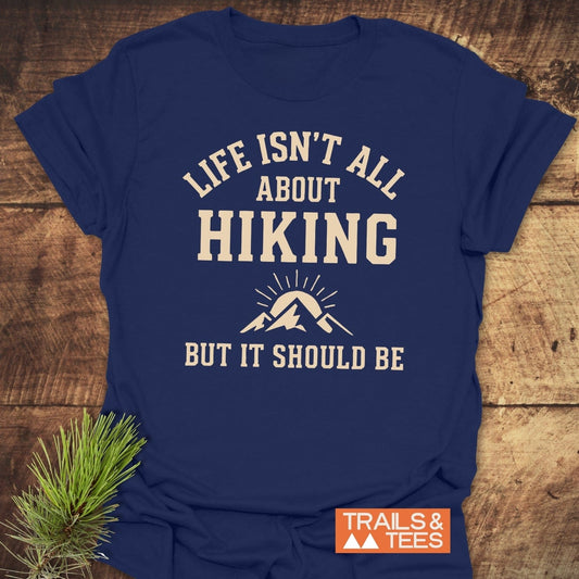 Navy-blue Life Isn't All About Hiking T-shirt with cream lettering and mountain graphic, featuring durable prints and soft ring-spun cotton for outdoor enthusiasts.