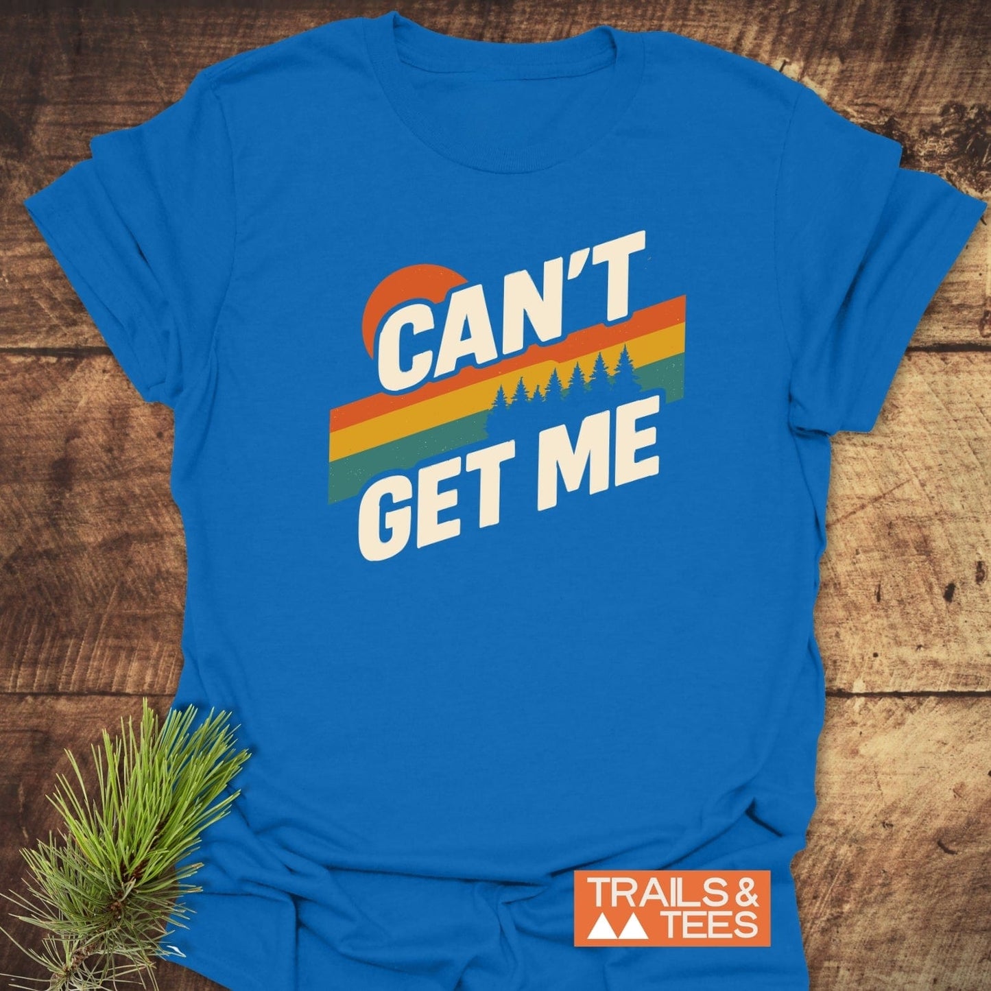 Can't Get Me Hiking T-Shirt with retro graphic and pine trees, crafted from soft ring-spun cotton for comfort and durability, featuring the Trails & Tees logo.