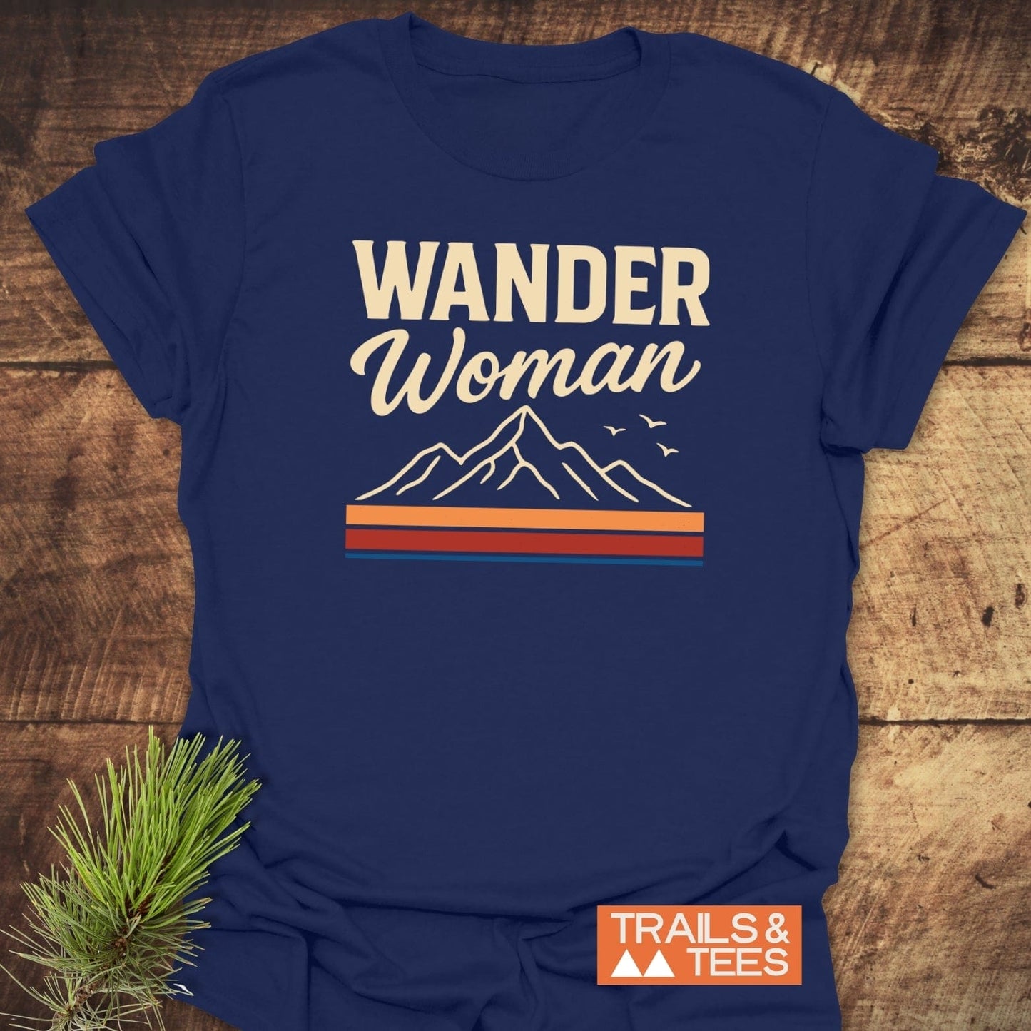 Wander Woman Graphic T-Shirt featuring cream lettering, mountain art, and TRAILS & TEES logo. Crafted for comfort with durable prints and lightweight cotton.