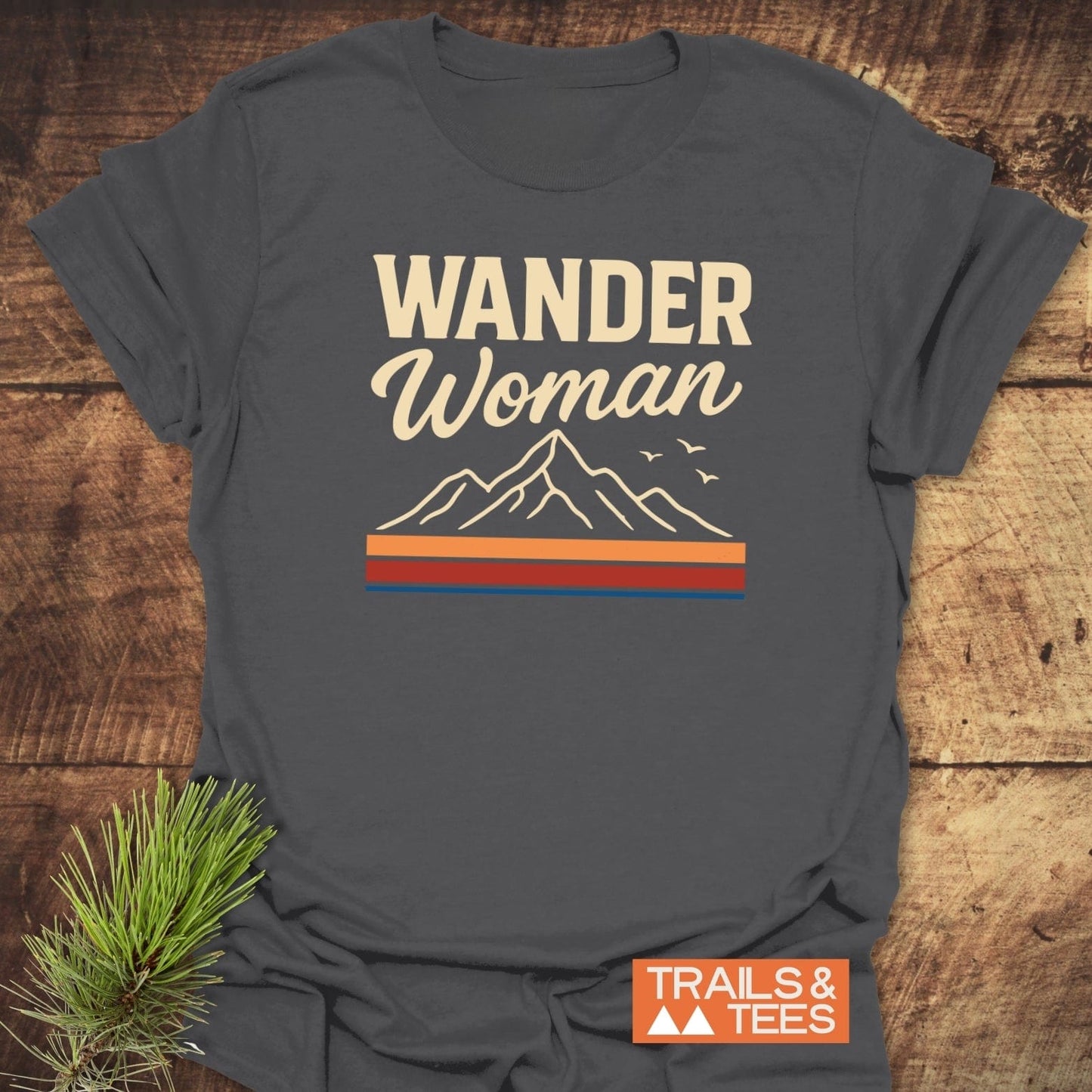Wander Woman Graphic T-Shirt featuring mountain line-drawing and slogan, crafted from soft ring-spun cotton for comfort and durability, ideal for outdoor enthusiasts.