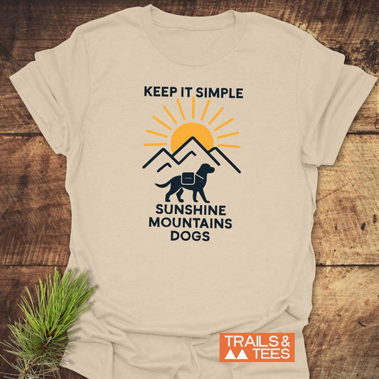 Minimalist Hiking Dog T-Shirt with a simple mountain design, orange sun, and dog silhouette. Features “KEEP IT SIMPLE” slogan. Durable, soft cotton for outdoor enthusiasts.