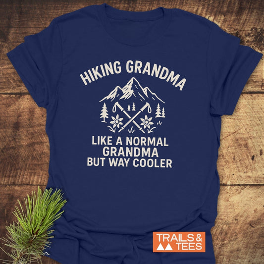 Hiking Grandma Mountain T-Shirt featuring a mountain and pine design with hiking poles. Made from soft cotton, perfect for outdoor enthusiasts.