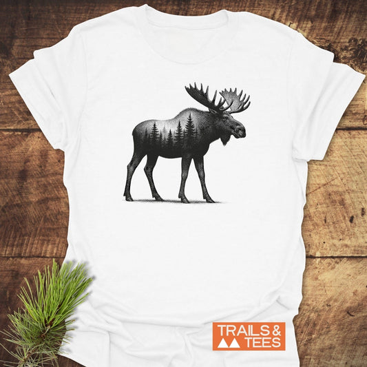 Moose Halftone T-Shirt on rustic wood, features a moose silhouette with pine forest, “TRAILS & TEES” logo, crafted for comfort and adventure.