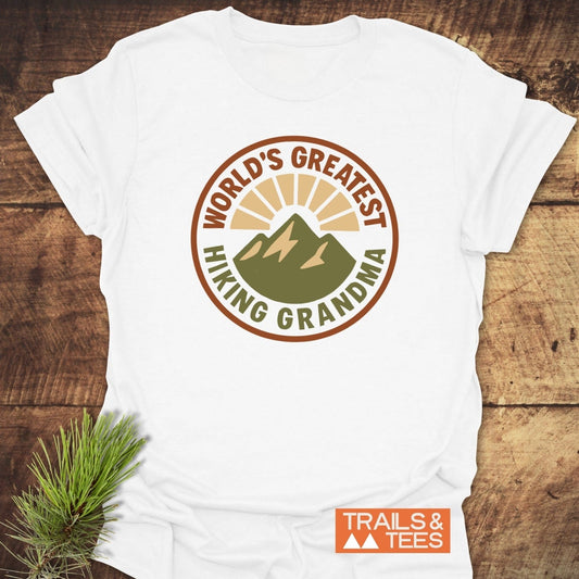 Greatest Hiking Grandma T-Shirt with mountain graphic, crafted from soft, lightweight cotton. Features durable print, taped shoulders, and no side seams for lasting comfort.