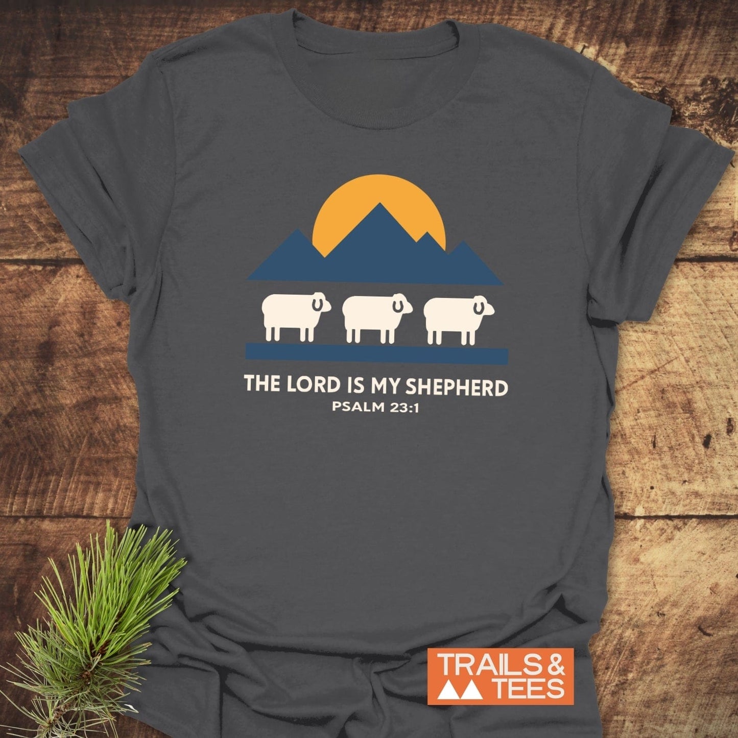The Lord Is My Shepherd T-Shirt featuring a mountain and sheep design, crafted from soft cotton, ideal for outdoor adventures, with durable prints and a comfortable fit.