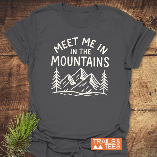 Meet Me In The Mountains T-Shirt featuring white mountain design on charcoal-gray. Crafted from soft, ring-spun cotton for comfort and durability.