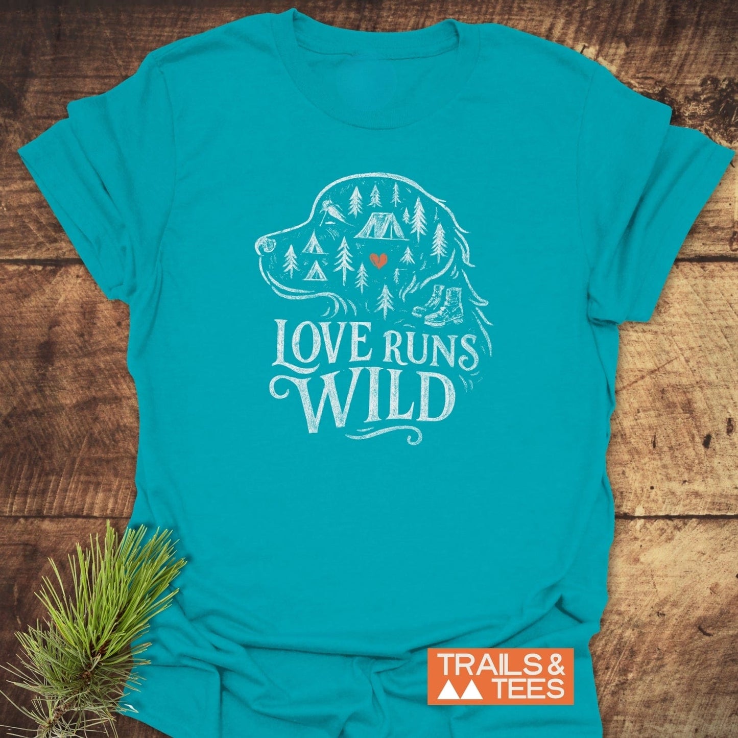 Love Runs Wild T-Shirt featuring a dog silhouette with outdoor icons, slogan, and Trails & Tees logo, crafted for comfort and adventure.
