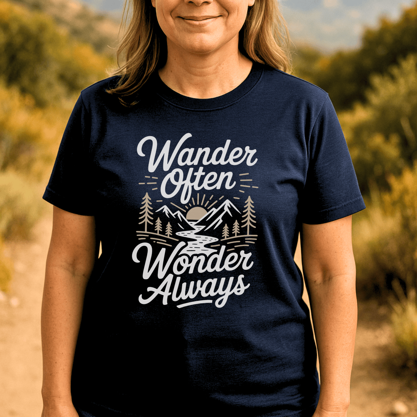 Person wearing the Wander Often T-Shirt, featuring a mountain-and-forest scene with slogan, ideal for outdoor enthusiasts seeking comfort and style on adventures.