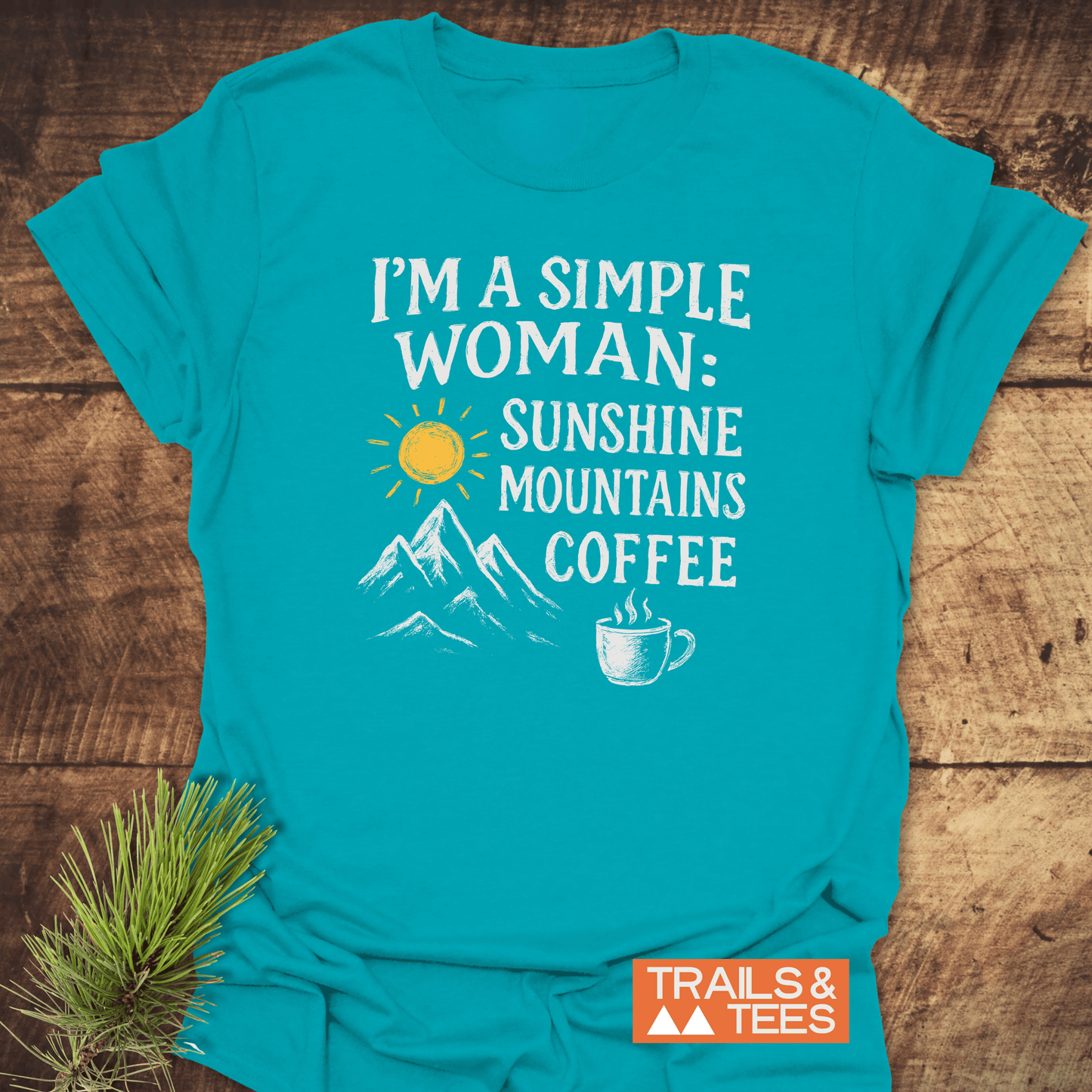 Simple Woman Sunshine T-Shirt with sun, mountains, and coffee graphics on a teal shirt, highlighting outdoor love. Durable, comfortable, and sustainably printed.
