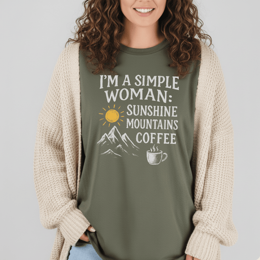 Simple Woman Sunshine T-Shirt with sun, mountains, coffee graphic; worn under cream cardigan. Soft, lightweight cotton for comfort and adventure.