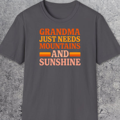 Retro 80s Grandma Mountains T-Shirt laid flat, features warm-toned text celebrating nature. Made from soft, ring-spun cotton for comfort and durability.