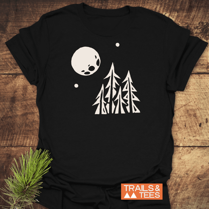 Pine Trees and Full Moon T-Shirt featuring a white forest scene and moon. Made from soft ring-spun cotton for comfort and durability.