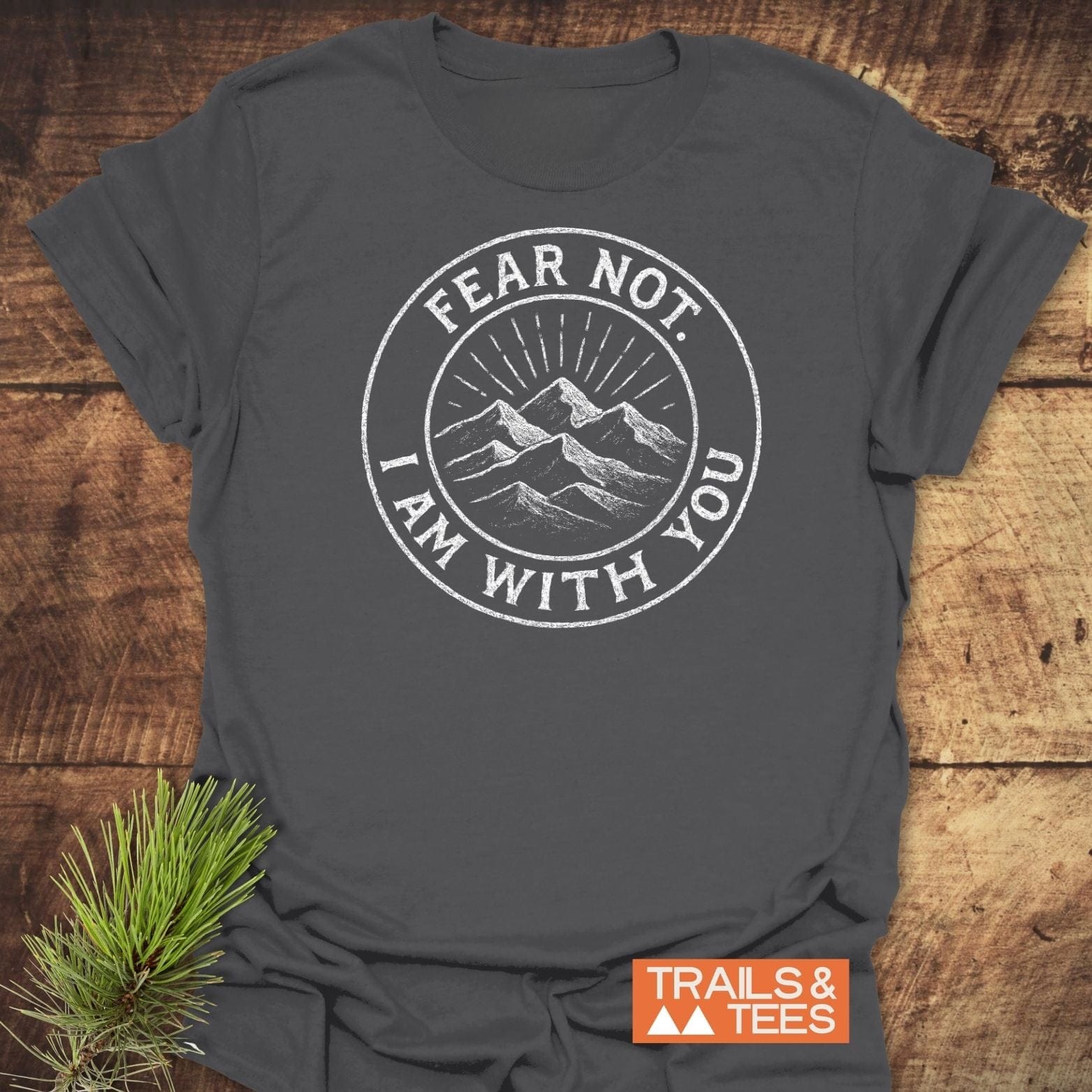 Fear Not Mountain T-Shirt featuring a circular graphic with mountain peaks and the message FEAR NOT. I AM WITH YOU. Laid flat with TRAILS & TEES logo visible.