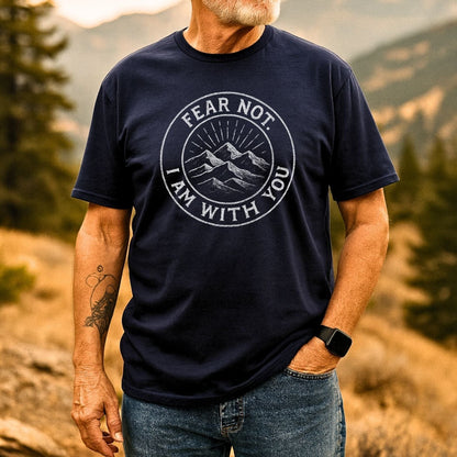 Bearded man outdoors wearing the Fear Not Mountain T-Shirt, featuring a mountain graphic and motivational text, showcasing its comfort and design for outdoor enthusiasts.