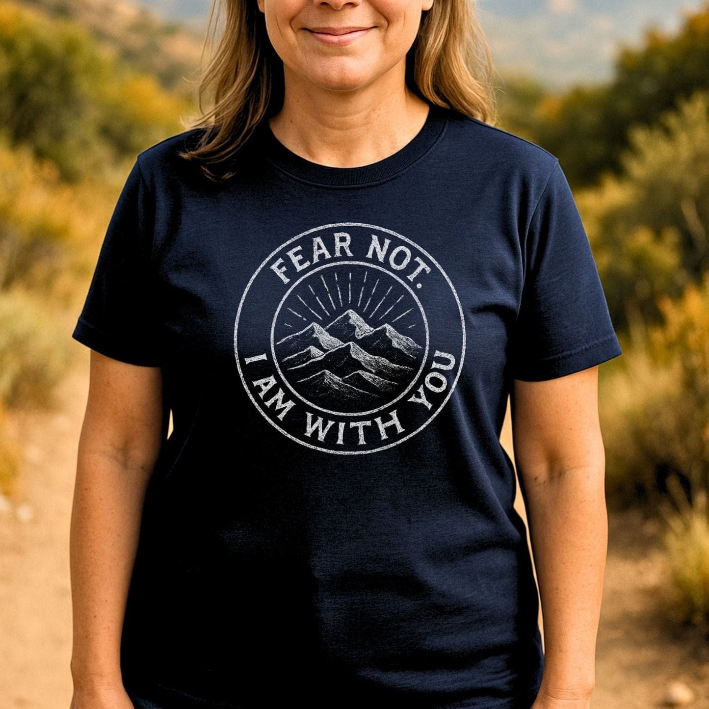 Fear Not Mountain T-Shirt featuring a circular mountain graphic and motivational text, worn by a person outdoors, highlighting comfort and adventure-ready design.