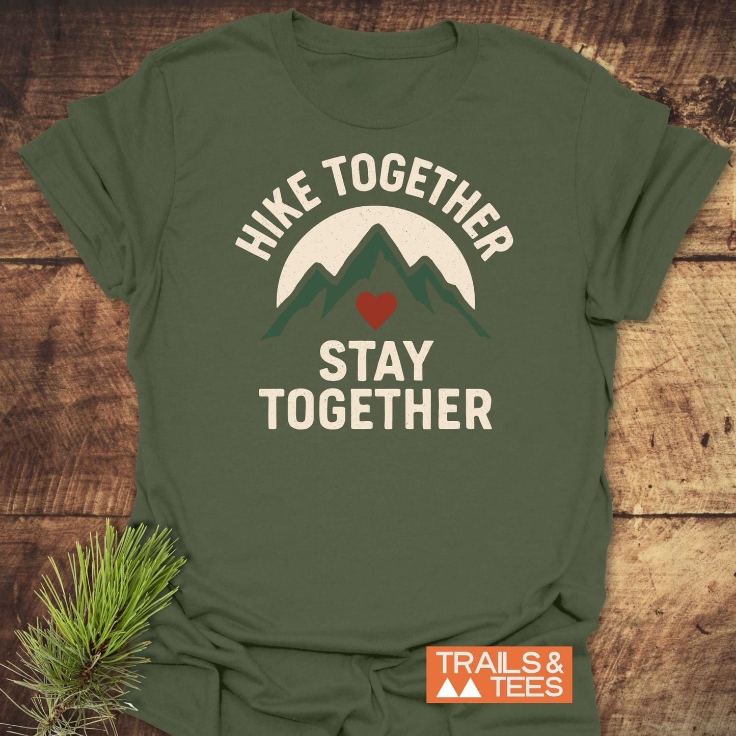 Hike Together Couple T-Shirt featuring a mountain and sun design, crafted from soft ring-spun cotton, ideal for outdoor lovers. Label reads TRAILS & TEES.