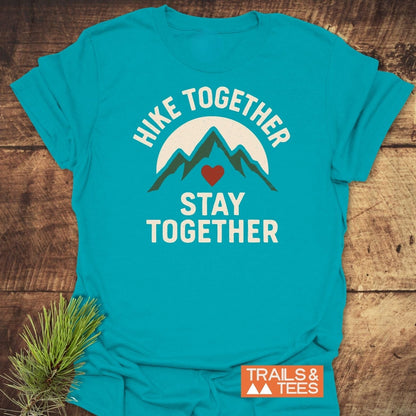Teal T-shirt featuring mountain graphic with a sun and heart, labeled Hike Together, Stay Together, by Trails & Tees. Crafted from soft, durable cotton.