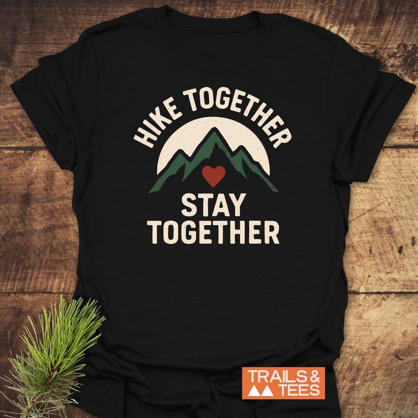 Hike Together Couple T-Shirt featuring green mountain peaks graphic with HIKE TOGETHER, STAY TOGETHER text, crafted from soft, lightweight cotton for outdoor enthusiasts.