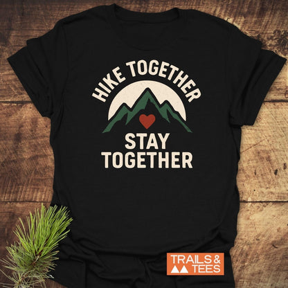 Hike Together Couple T-Shirt featuring green mountain peaks graphic with HIKE TOGETHER, STAY TOGETHER text, crafted from soft, lightweight cotton for outdoor enthusiasts.
