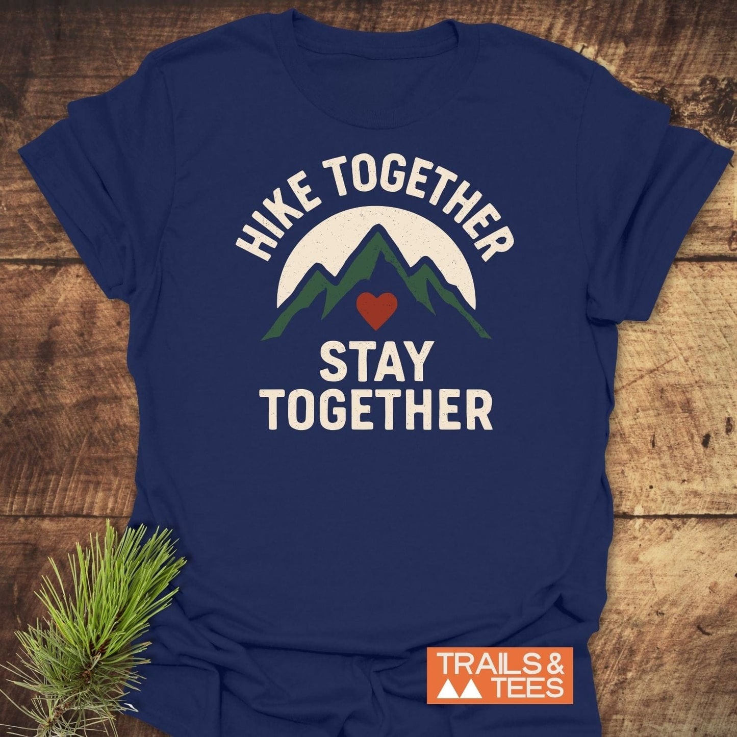 Hike Together Couple T-Shirt featuring green mountain peaks and red heart graphic, crafted from soft ring-spun cotton for comfort and durability.
